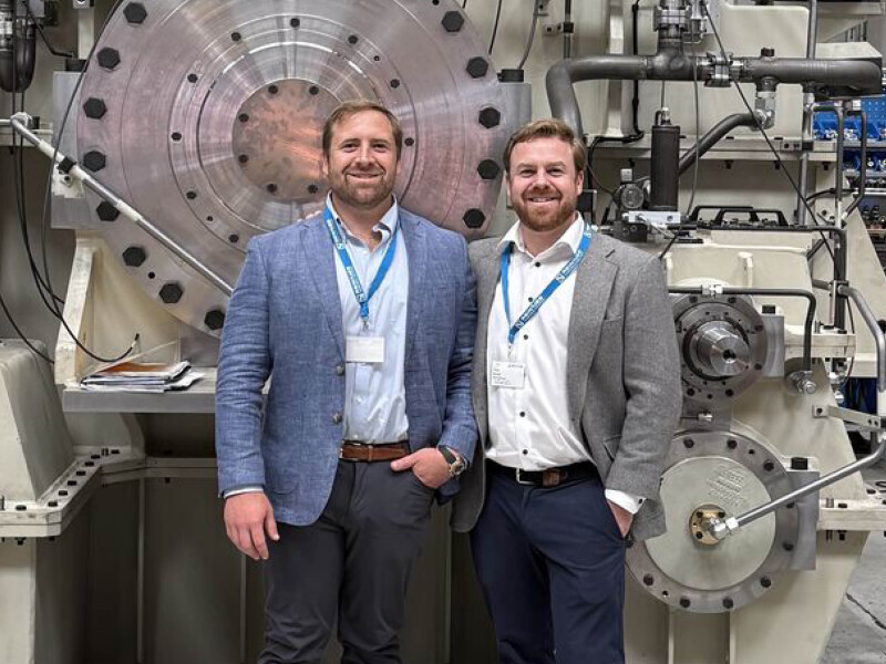 Karl and Chris Senner standing in front of industrial marine propulsion equipment